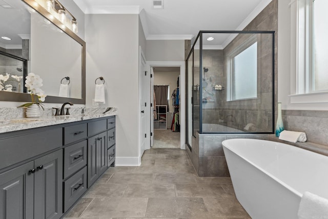 bathroom with ornamental molding, independent shower and bath, and vanity