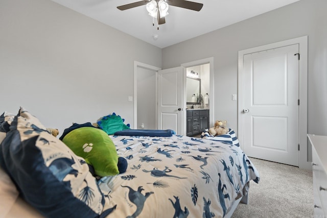 carpeted bedroom with sink, ceiling fan, and ensuite bathroom