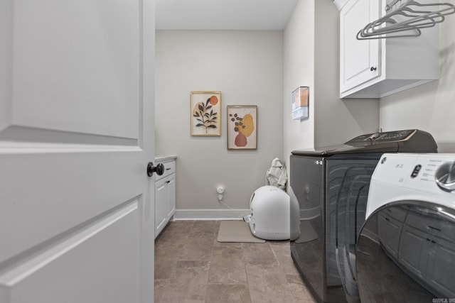 washroom featuring cabinets and washing machine and dryer