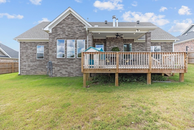 rear view of house with a lawn, ceiling fan, and a deck