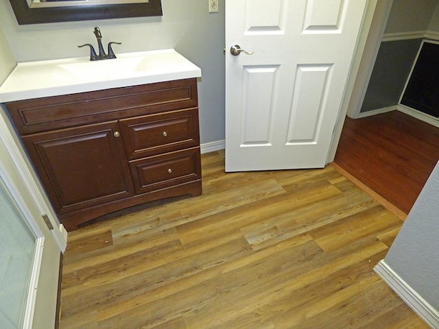 bathroom with vanity and hardwood / wood-style floors