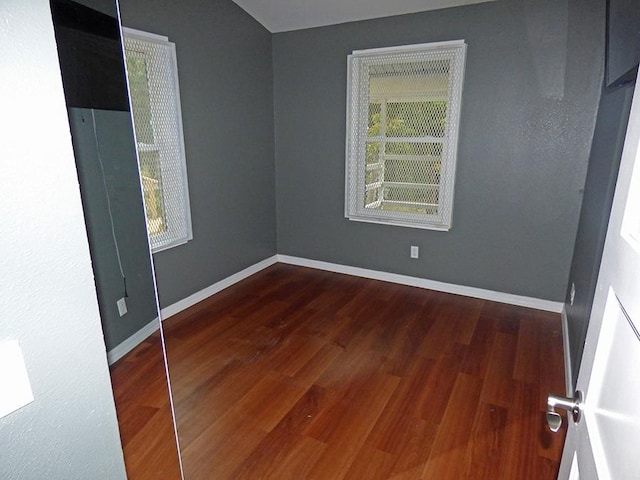 unfurnished room with dark hardwood / wood-style floors