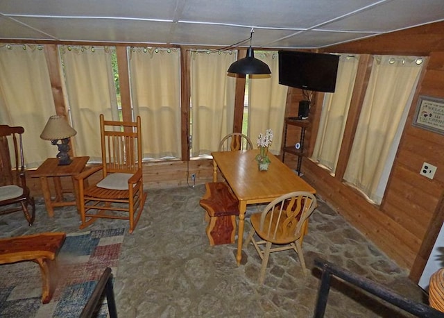 dining area with wooden walls