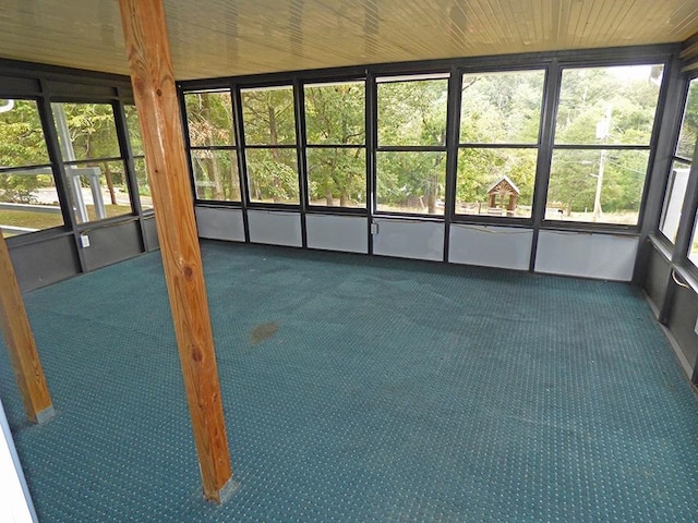 unfurnished sunroom with wood ceiling and a wealth of natural light