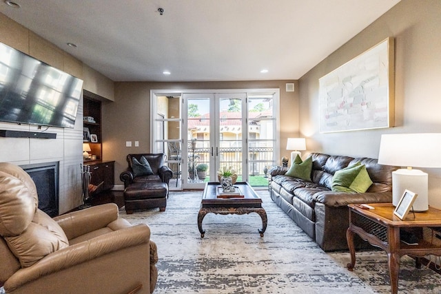 living room featuring a tiled fireplace