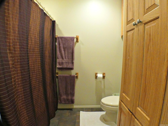 bathroom with tile patterned floors and toilet