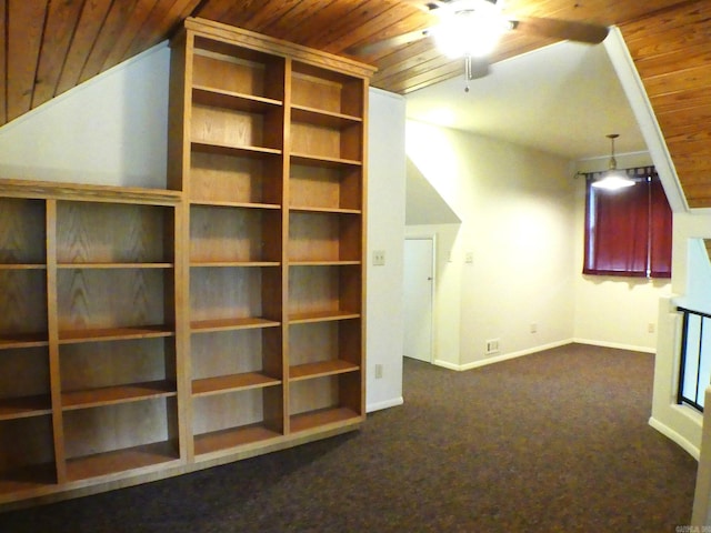 interior space with wood ceiling, dark carpet, and ceiling fan