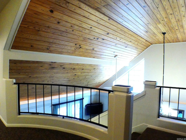 stairway featuring lofted ceiling and wooden ceiling