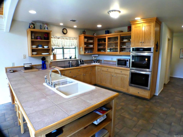 kitchen with sink, stainless steel appliances, and tile countertops