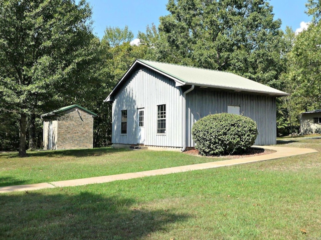 view of property exterior featuring a lawn and a storage shed