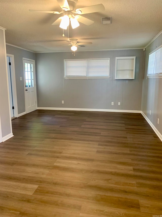 spare room with ornamental molding, ceiling fan, dark wood-type flooring, and a textured ceiling