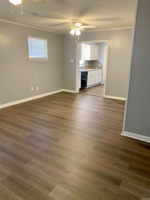 unfurnished living room with ceiling fan, sink, a textured ceiling, crown molding, and dark hardwood / wood-style flooring