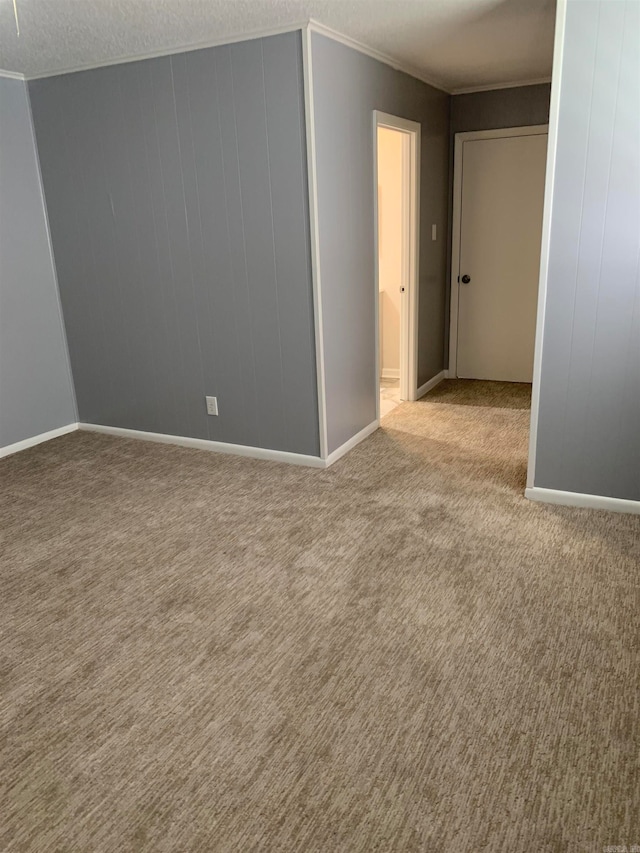 carpeted empty room with a textured ceiling