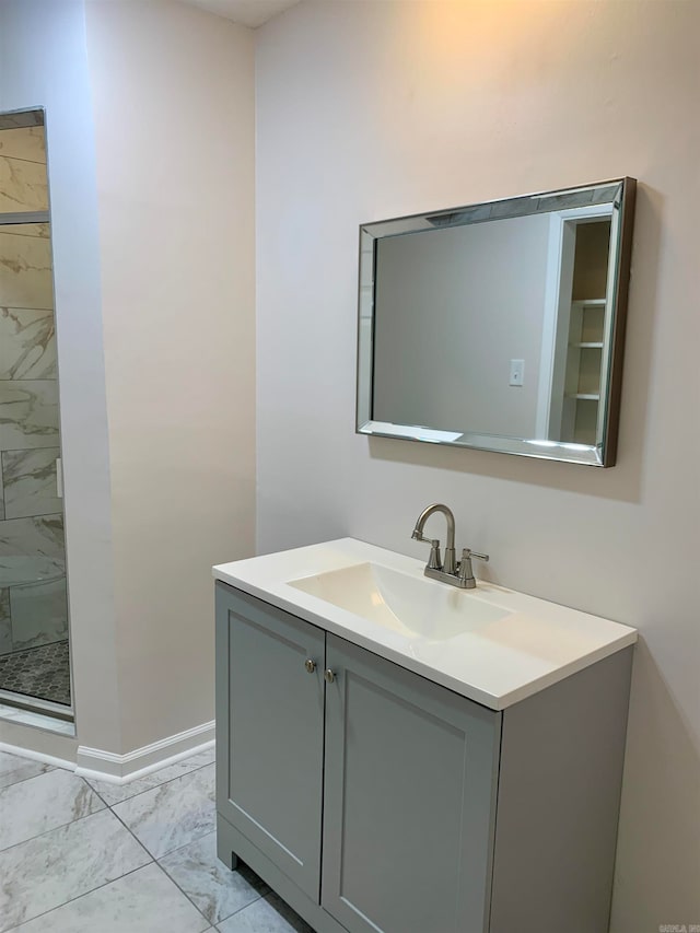 bathroom featuring a tile shower and vanity