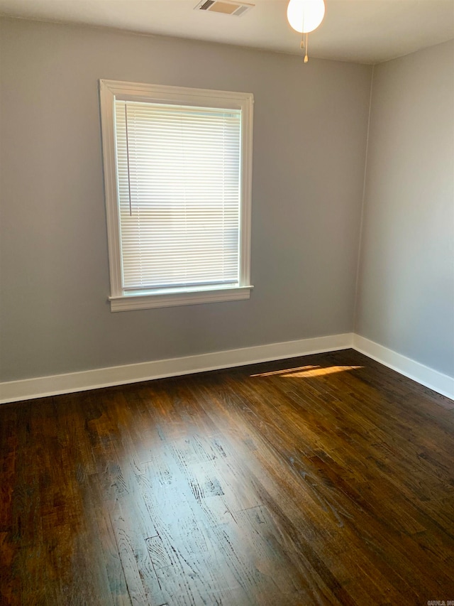 empty room featuring ceiling fan and dark hardwood / wood-style floors