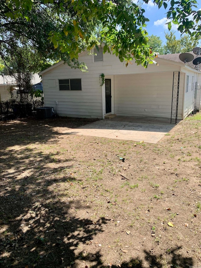 rear view of house featuring central AC and a patio area