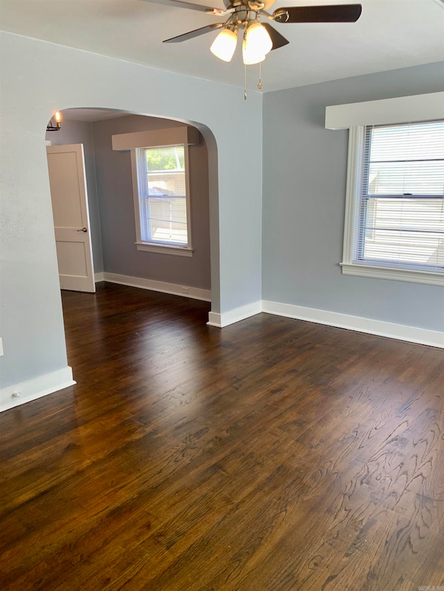 empty room featuring ceiling fan and dark hardwood / wood-style flooring