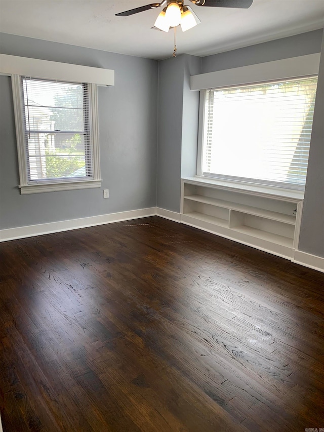 spare room featuring ceiling fan, plenty of natural light, and dark hardwood / wood-style flooring