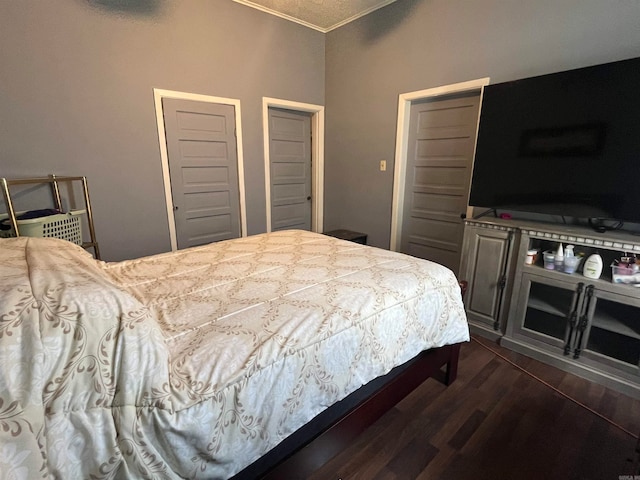 bedroom featuring ornamental molding and dark hardwood / wood-style flooring