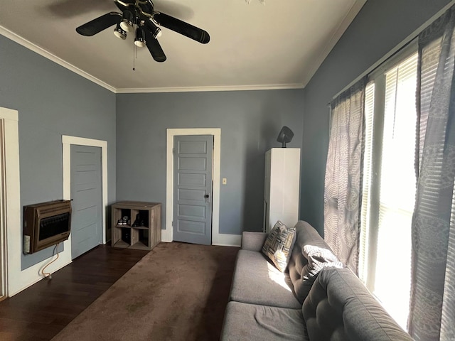 living room featuring heating unit, ornamental molding, dark wood-type flooring, and ceiling fan