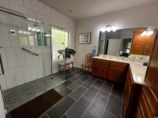 bathroom featuring tile patterned flooring, a shower with door, and vanity