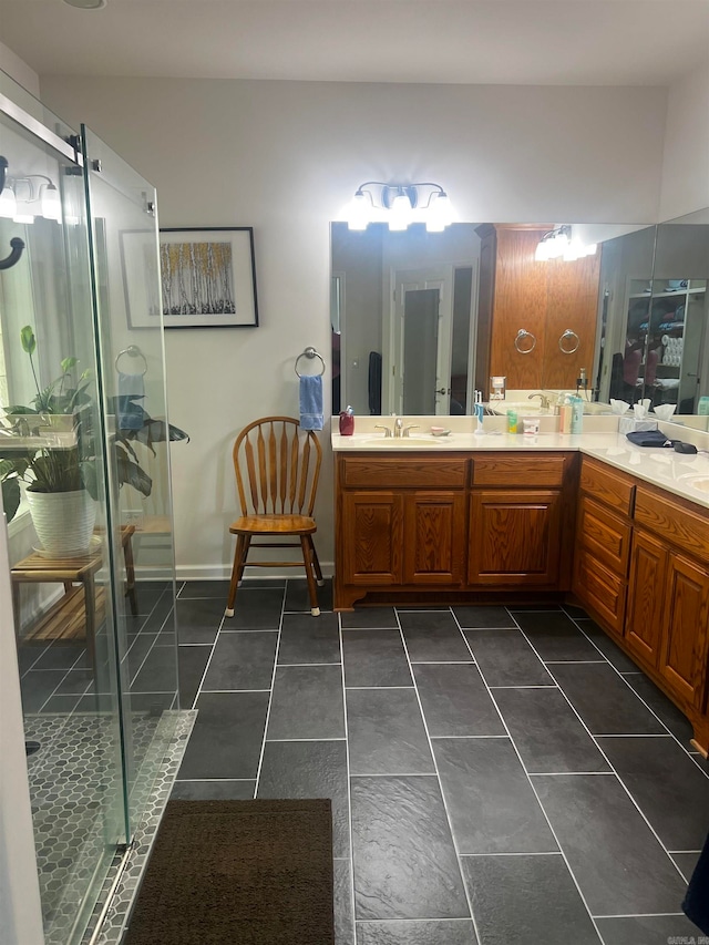 bathroom featuring tile patterned flooring, a shower with door, and vanity