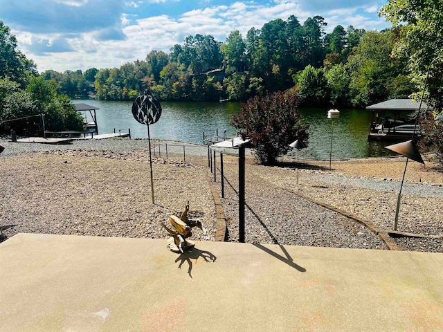 view of yard featuring a dock and a water view