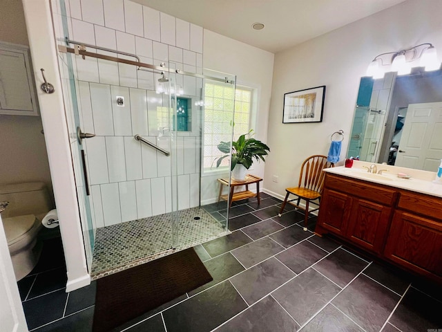 bathroom featuring vanity, toilet, an enclosed shower, and tile patterned floors