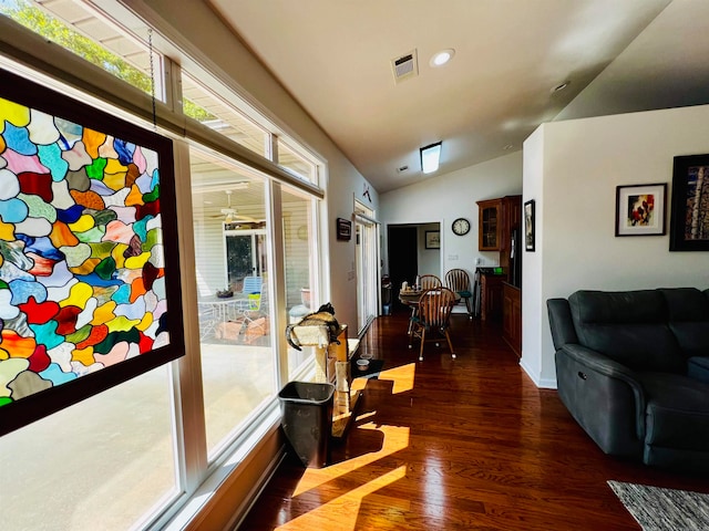 interior space with vaulted ceiling and dark wood-type flooring