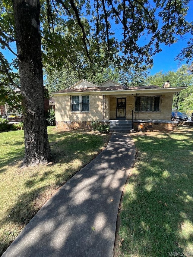 ranch-style house with a porch and a front yard