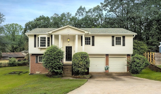 bi-level home with a front lawn and a garage