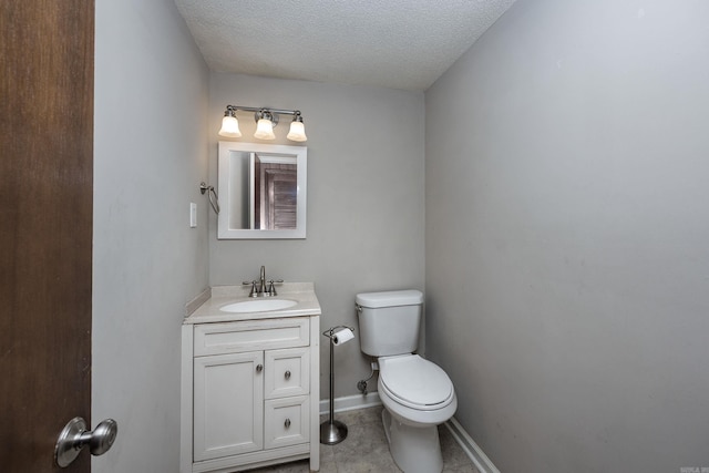 bathroom featuring a textured ceiling, tile patterned flooring, vanity, and toilet