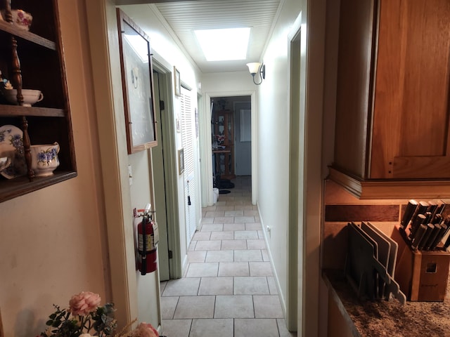 hall with light tile patterned floors