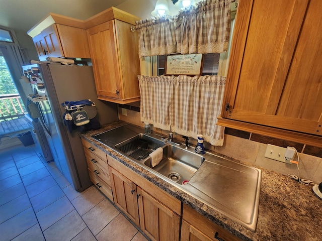 kitchen featuring light tile patterned flooring and stainless steel fridge