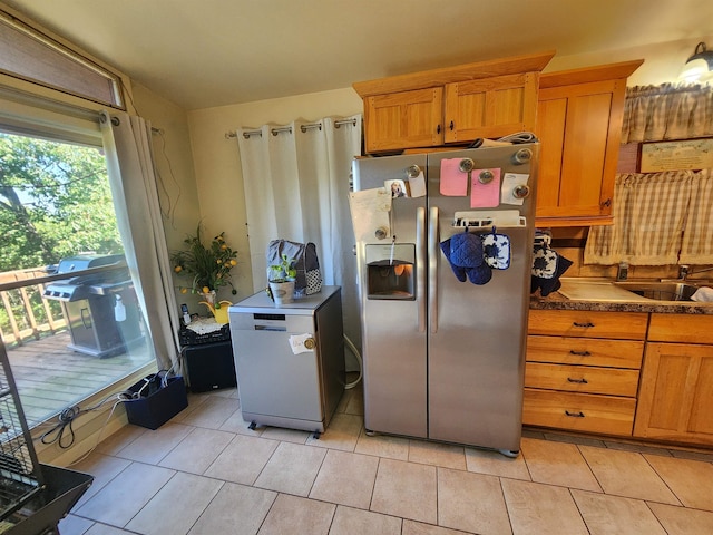 kitchen featuring stainless steel refrigerator with ice dispenser, sink, white fridge, and light tile patterned flooring