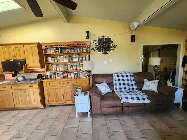 kitchen with ceiling fan, light brown cabinetry, and lofted ceiling with beams