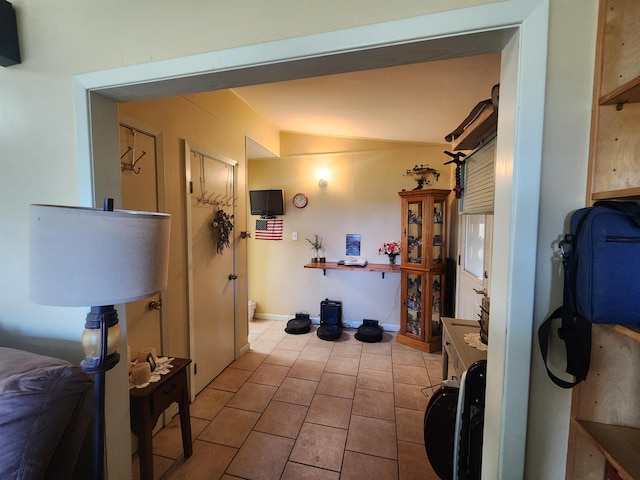 interior space featuring lofted ceiling and tile patterned floors