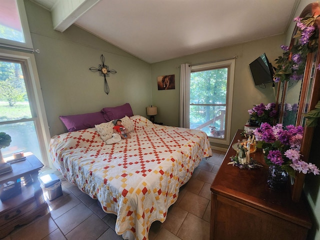 tiled bedroom with vaulted ceiling with beams and multiple windows