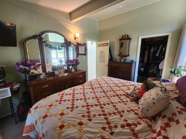 bedroom with beam ceiling and a closet