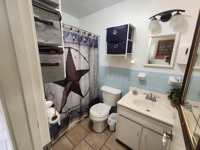 bathroom with vanity, tile patterned floors, tile walls, toilet, and a shower with shower curtain