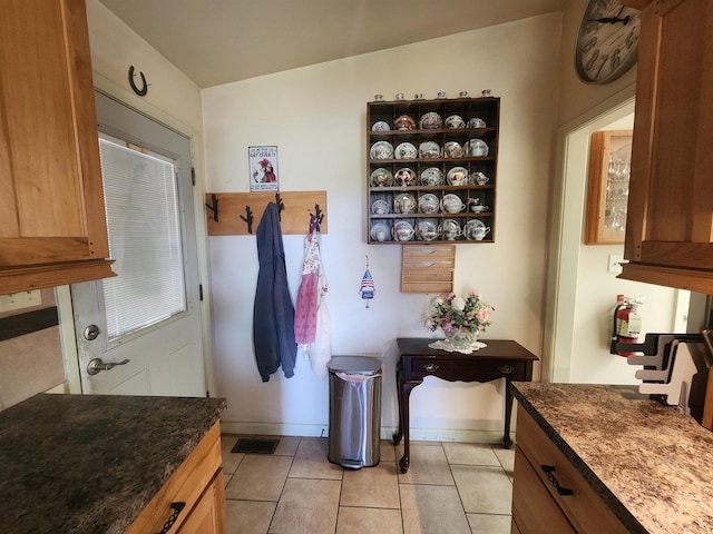 kitchen featuring light tile patterned flooring and vaulted ceiling