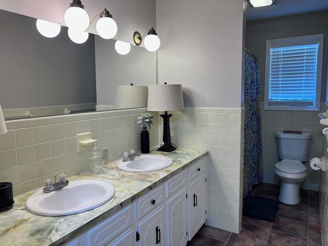 236 N Riverview Ln, Mountain View, AR 72560 - bathroom with tile walls, tile patterned floors, double vanity, toilet, and a wainscoted wall