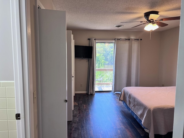 bedroom featuring a textured ceiling, ceiling fan, access to outside, and dark hardwood / wood-style flooring