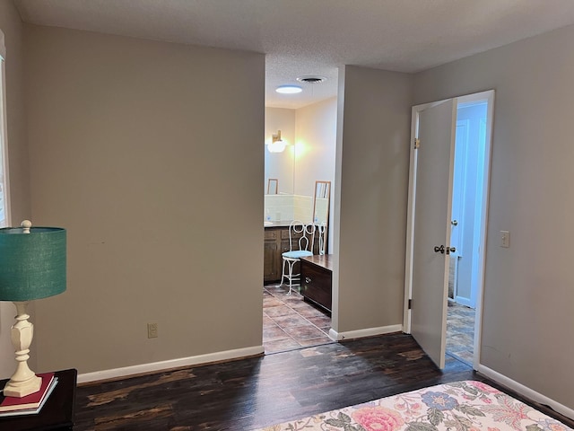 bedroom with light hardwood / wood-style flooring and a textured ceiling