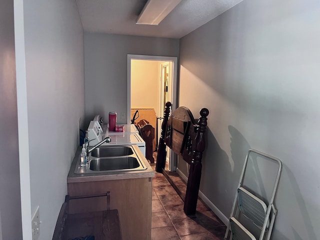 interior space featuring sink and dark tile patterned floors