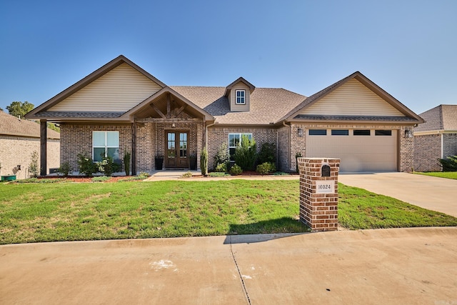 view of front of house with a garage and a front lawn