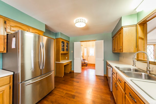 kitchen with sink, stainless steel appliances, and dark wood-type flooring