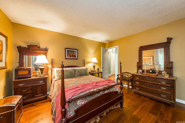 bedroom with a textured ceiling and hardwood / wood-style floors