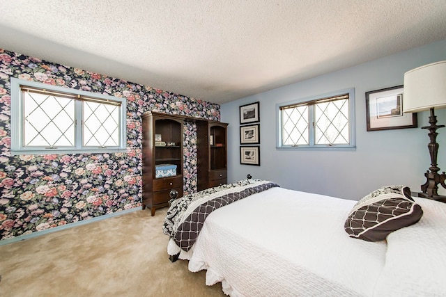 carpeted bedroom featuring a textured ceiling