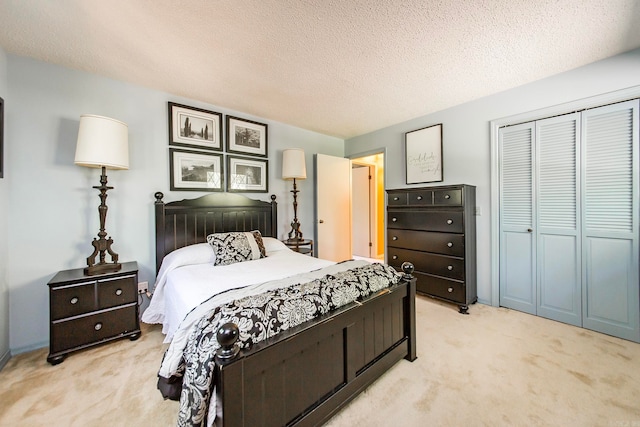 bedroom featuring a closet, light colored carpet, and a textured ceiling